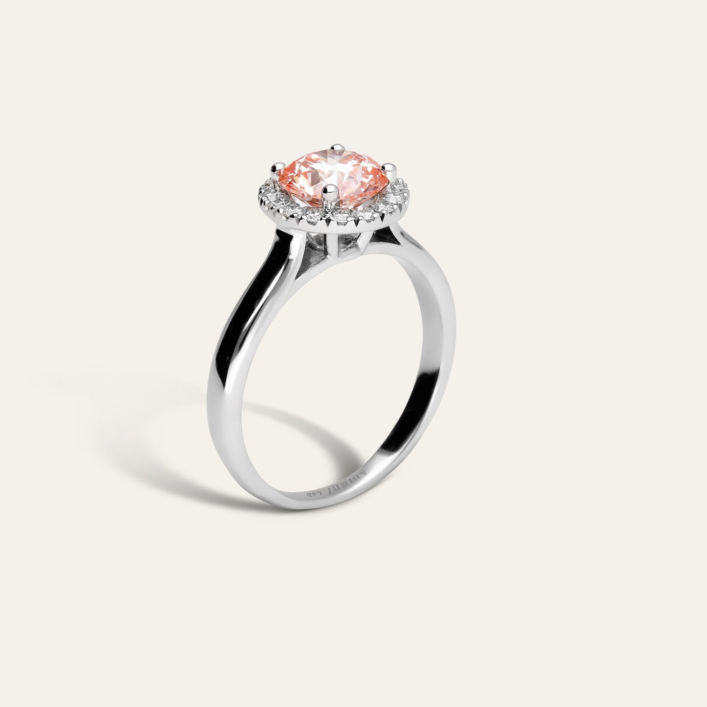 Classic round engagement ring with halo in fancy pink (1.50 ct)