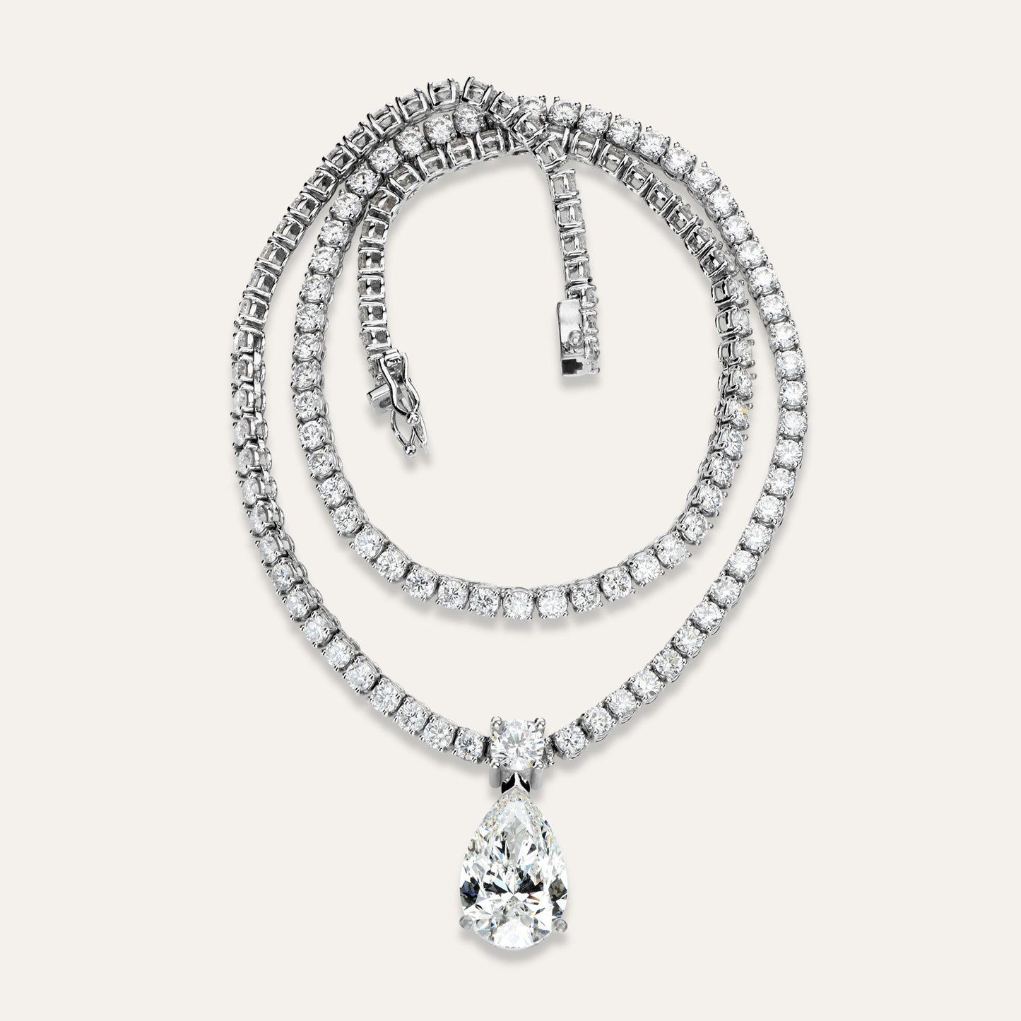 Diamond necklace with a teardrop pendant on a light gray background