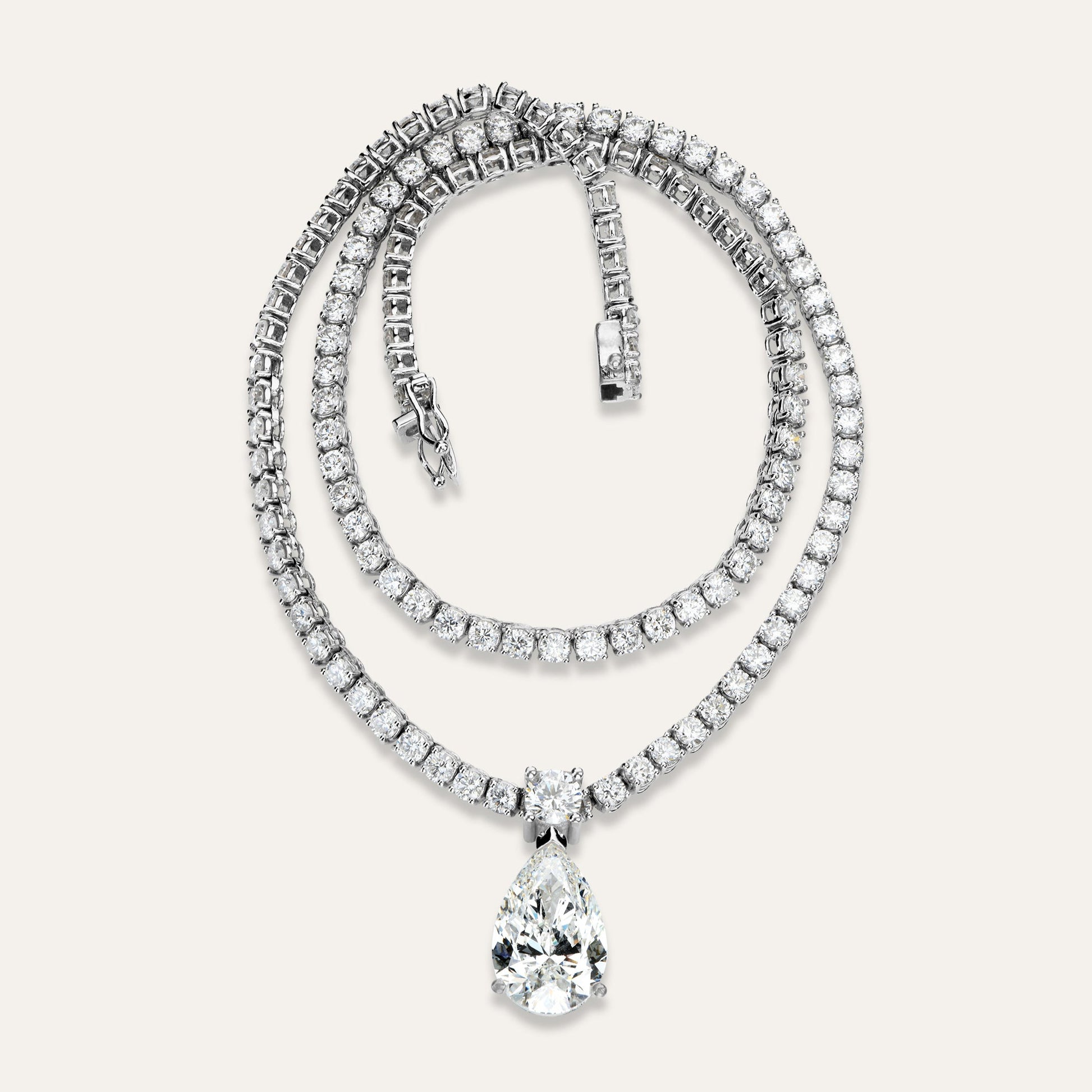 Diamond necklace with a teardrop pendant on a light gray background