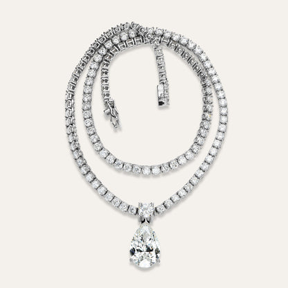 Diamond necklace with a teardrop pendant on a light gray background