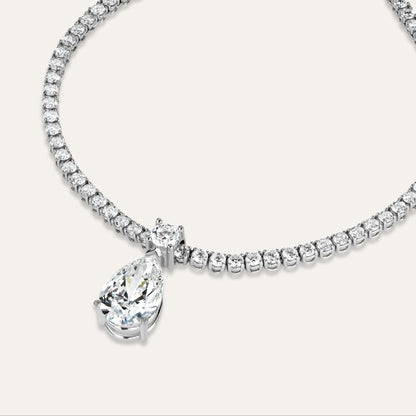 Diamond necklace with a pear shaped pendant on a white background