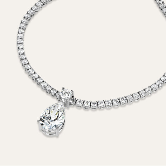 Diamond necklace with a pear shaped pendant on a white background